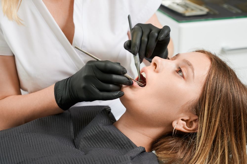 a girl is getting dental treatment